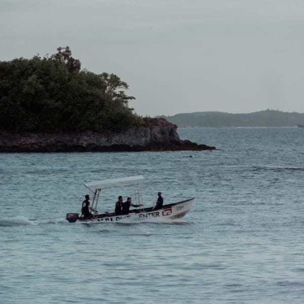 MBI dive boat heading past the Malapascua headland at dusk after an afternoon dive